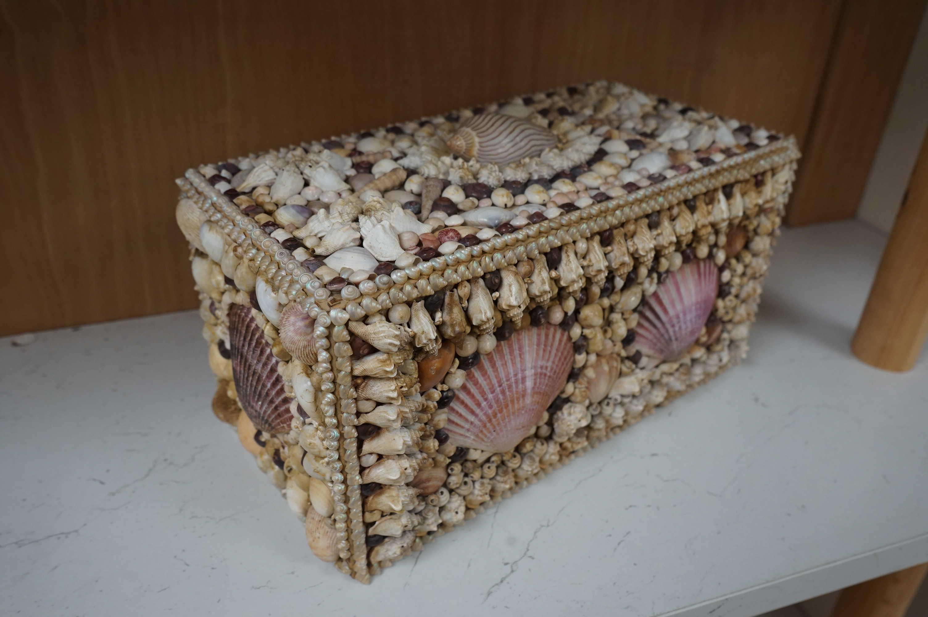 A George III tea caddy, shell covered in 19th century. 32cm wide x 15cm high x 17cm deep. Condition - a few shells missing but appears in good condition